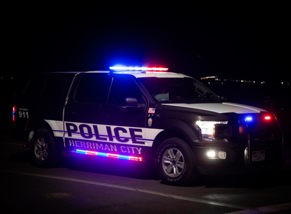 A Herriman Police truck flashes its lights at night in 2020